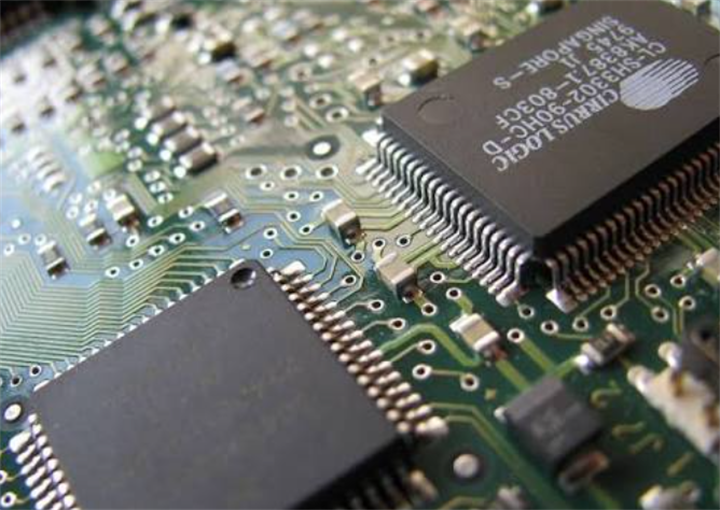 Close-up macro shot of integrated circuit chips soldered onto printed circuit board, showcasing semiconductor components assembled in Penang