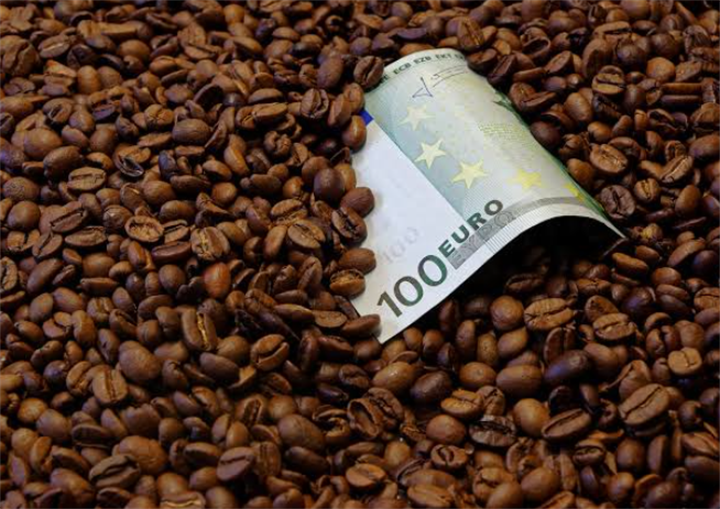 100 euro banknote laid on top of roasted coffee beans, symbolizing volatile coffee market valuations