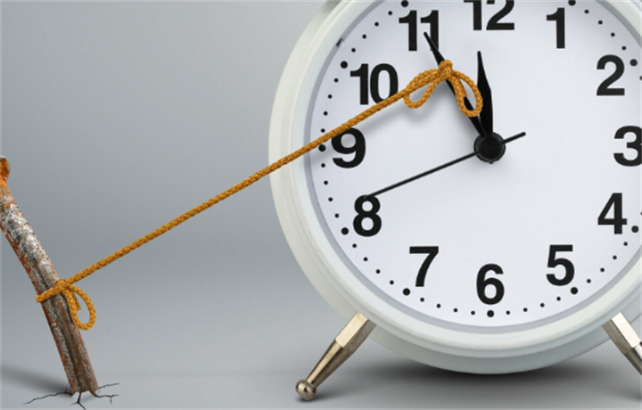Clock tied with rope to a rusted metal stake, symbolizing artificially stalled and fake delayed payment timelines