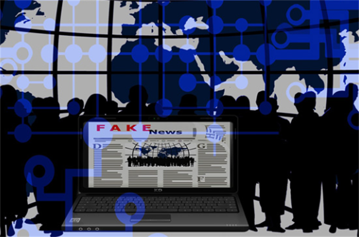Laptop displaying fake news webpage over global network graphic, showing wide online spread of false financial information