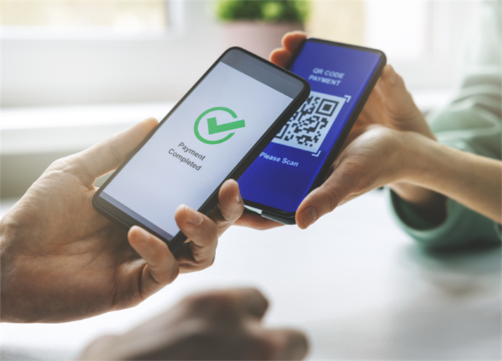 Two smartphones completing QR code scan payment, showing offline digital transaction success screen